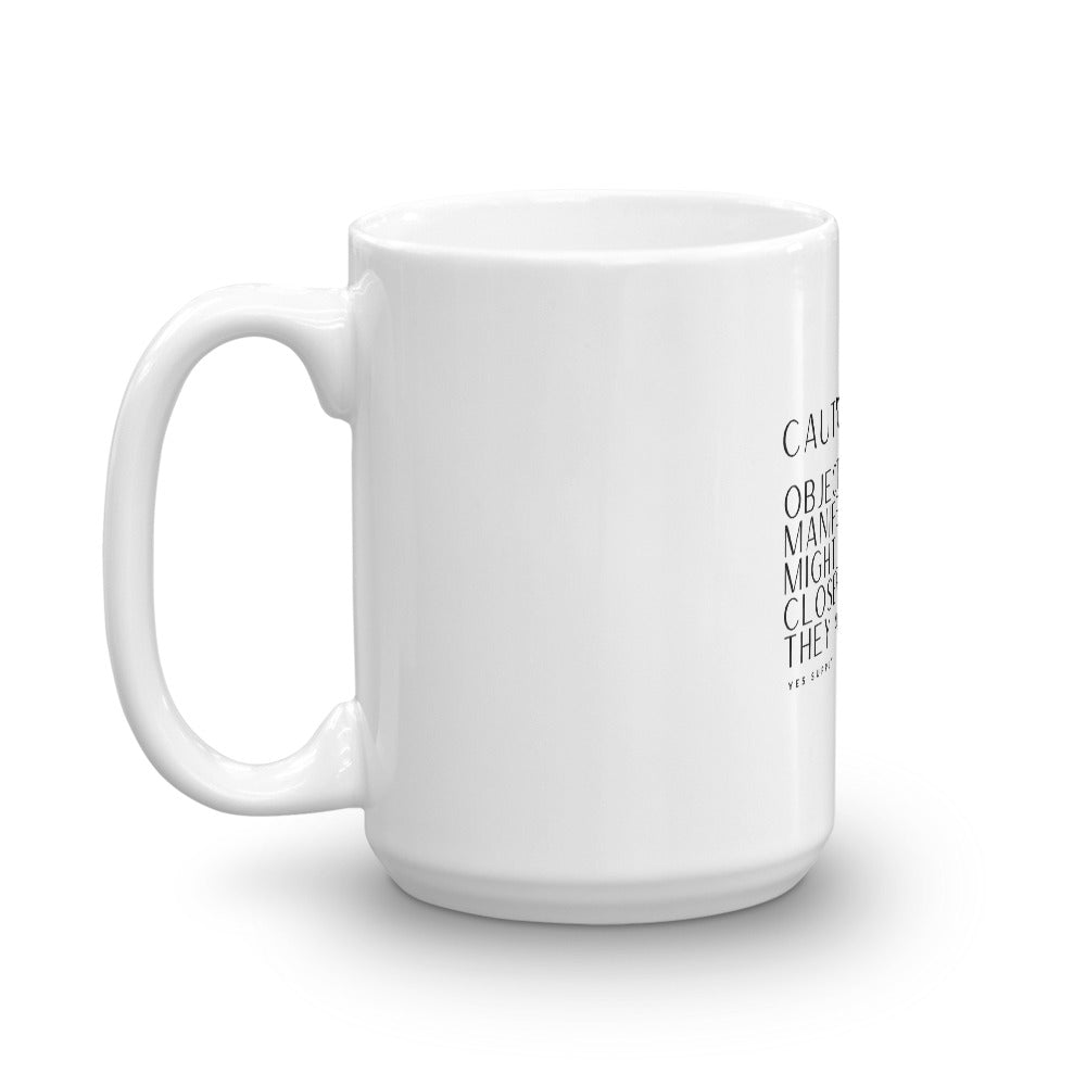 CAUTION: Objects In Manifestation Mug
